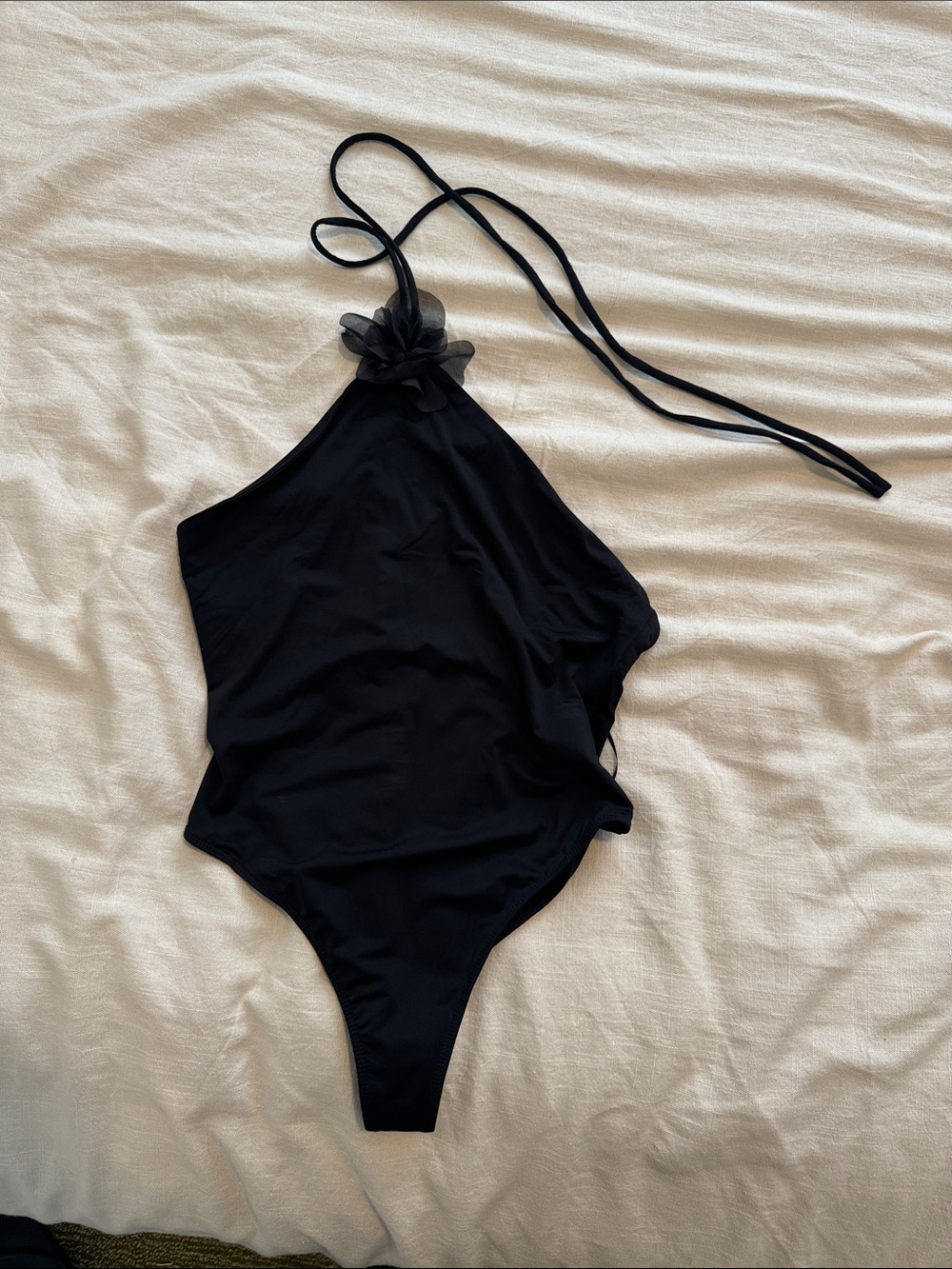 Revolve Black Halter-Style One-Piece Bodysuit with Floral Accent